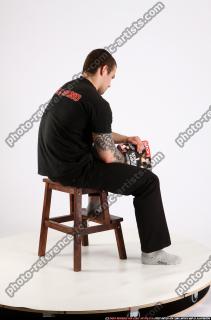 Alex Sitting With Pistol Pose